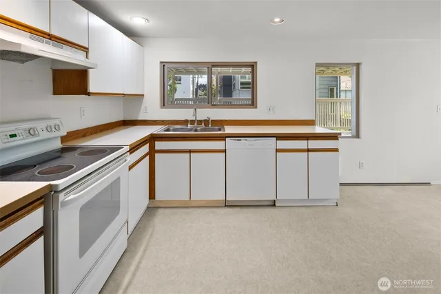 a kitchen with a sink stove and cabinets
