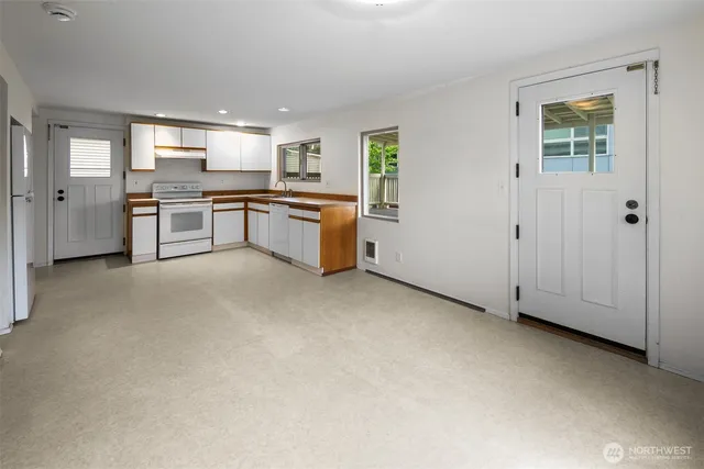 a large kitchen with cabinets and stainless steel appliances