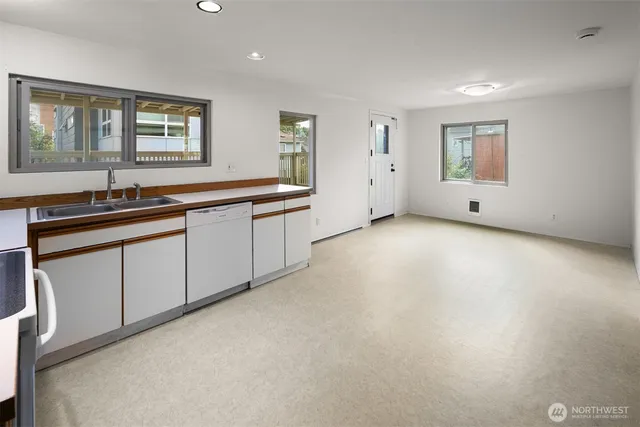 a view of a big room with windows and cabinet