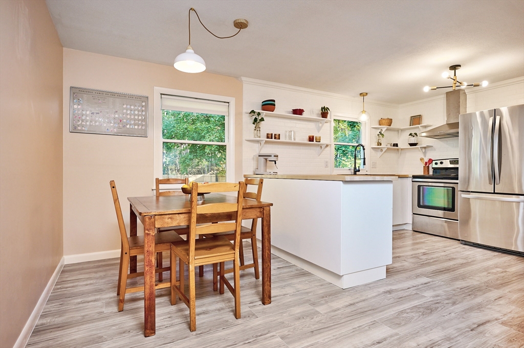 795 A Westhampton Road Northampton, MA 01062 - Photo 8 of 25 a kitchen with stainless steel appliances a dining table chairs refrigerator and sink