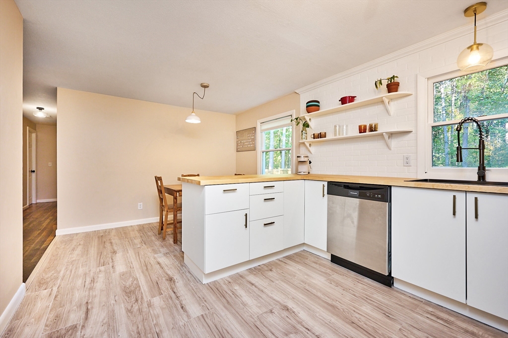 795 A Westhampton Road Northampton, MA 01062 - Photo 9 of 25 a kitchen with white cabinets and wooden floor