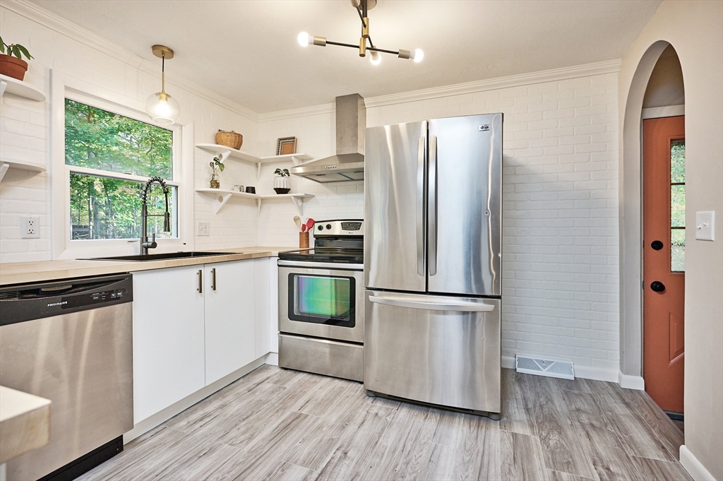 795 A Westhampton Road Northampton, MA 01062 - Photo 10 of 25 a kitchen with stainless steel appliances a refrigerator sink and wooden floor