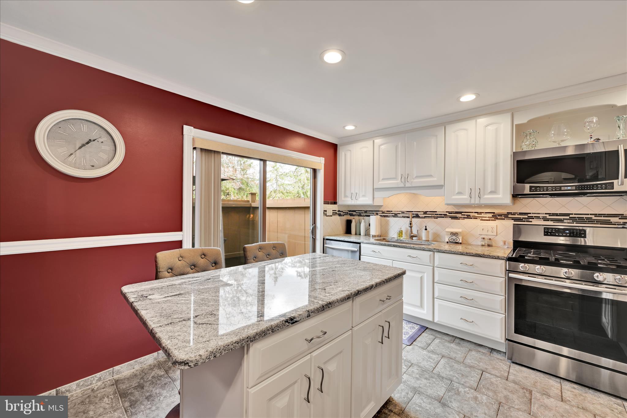 57 Wood Circle Reading, PA 19607 - Photo 15 of 46 a kitchen with granite countertop a stove a sink and a microwave