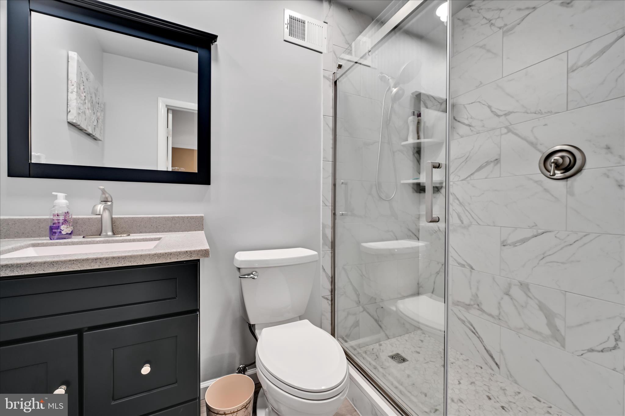 57 Wood Circle Reading, PA 19607 - Photo 32 of 46 a bathroom with a toilet a sink a mirror and vanity