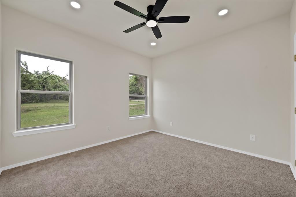 501 Harris Road Azle, TX 76020 - Photo 13 of 29 an empty room with a window and a fan