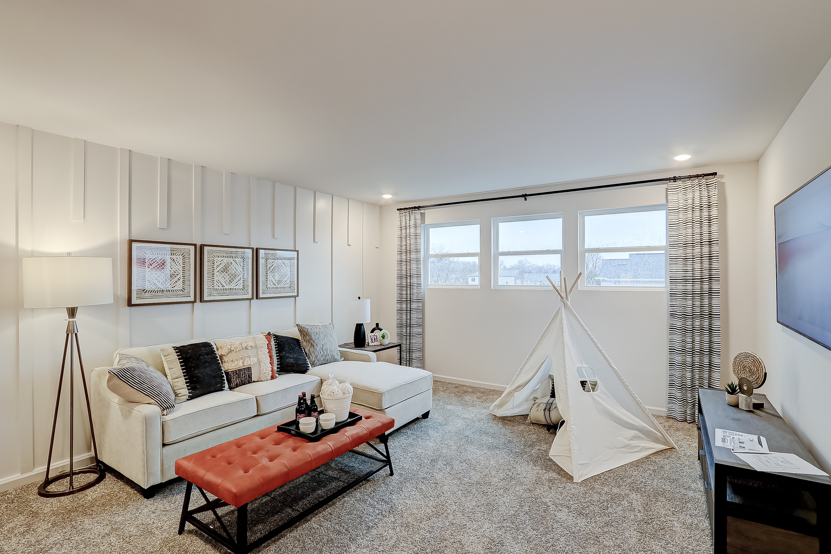 313 Monica Lane Oswego, IL 60543 - Photo 22 of 34 a living room with furniture a flat screen tv and a large window