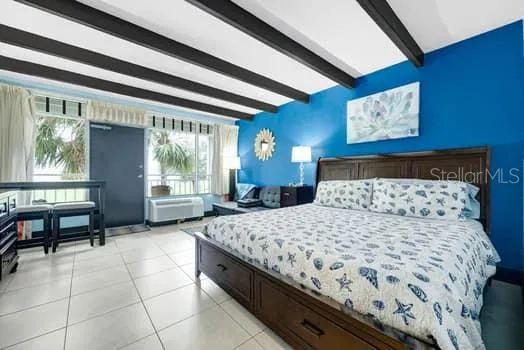 a bedroom with a bed and window