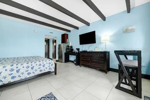 a bedroom with furniture and flat screen tv