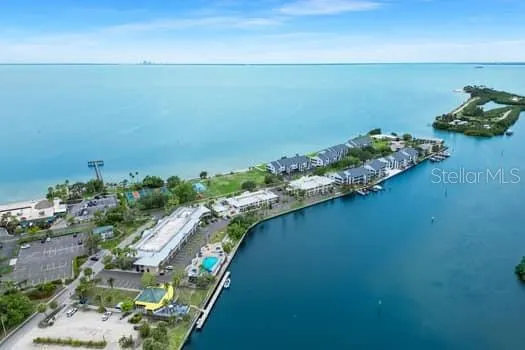 an aerial view of a houses with a lake view