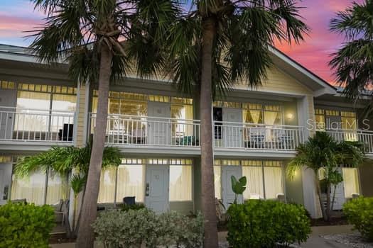 611 Destiny Drive, Unit 210 Ruskin, FL 33570 - Photo 2 of 48 a front view of yellow house with a small yard