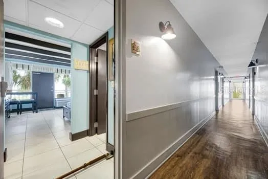 a view of a hallway with dining area and glass door