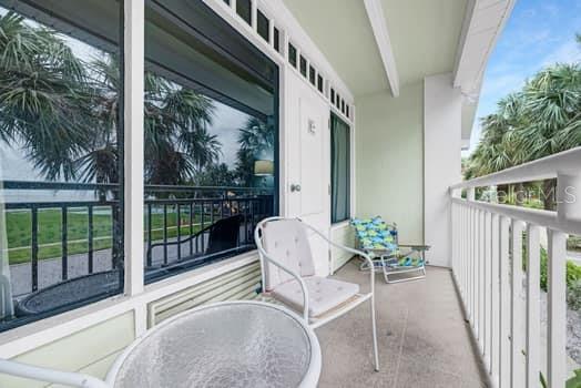 611 Destiny Drive, Unit 210 Ruskin, FL 33570 - Photo 22 of 48 a balcony with furniture and a potted plant