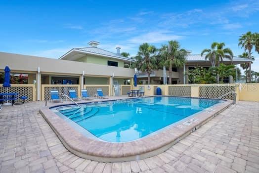 611 Destiny Drive, Unit 210 Ruskin, FL 33570 - Photo 23 of 48 swimming pool view with a seating space and a garden view