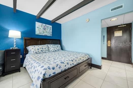 611 Destiny Drive, Unit 210 Ruskin, FL 33570 - Photo 32 of 48 a bedroom with a bed and a lamp