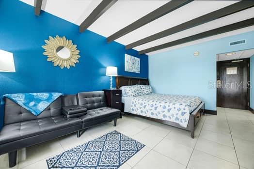 611 Destiny Drive, Unit 210 Ruskin, FL 33570 - Photo 35 of 48 a bedroom with a bed couch and window