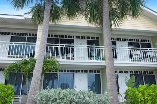 611 Destiny Drive, Unit 210 Ruskin, FL 33570 - Photo 36 of 48 a front view of multi story residential apartment building with a yard and potted plants