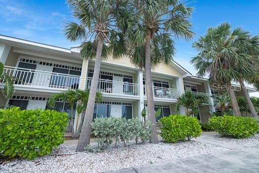 611 Destiny Drive, Unit 210 Ruskin, FL 33570 - Photo 37 of 48 a front view of residential houses with yard and green space