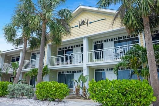 611 Destiny Drive, Unit 210 Ruskin, FL 33570 - Photo 38 of 48 a front view of a house with a garden