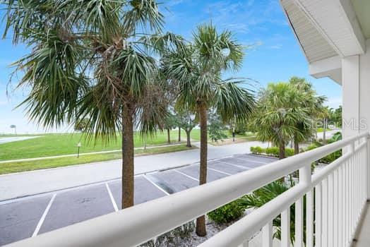 611 Destiny Drive, Unit 210 Ruskin, FL 33570 - Photo 41 of 48 a view of swimming pool with a garden and palm trees