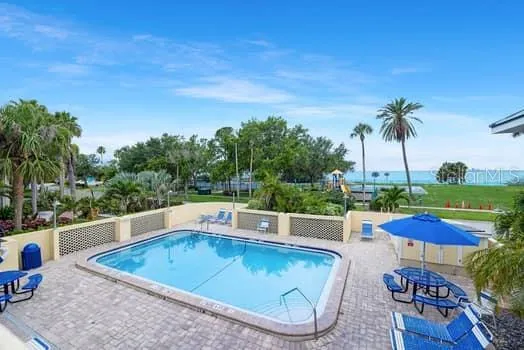 swimming pool view with a seating space