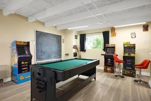 a room with pool table and windows