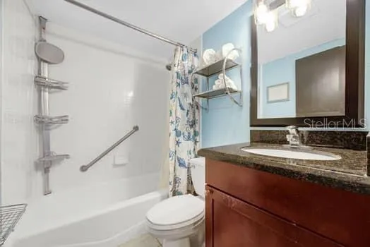 a bathroom with a granite countertop sink toilet a mirror and shower