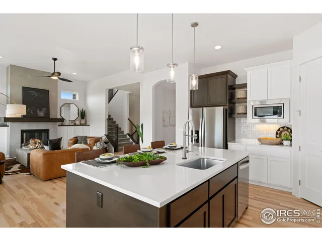a kitchen with stainless steel appliances kitchen island a sink a stove and a refrigerator