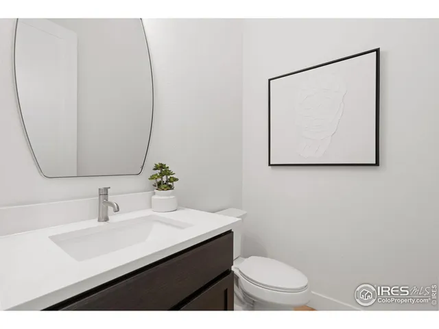 a bathroom with a sink mirror and toilet