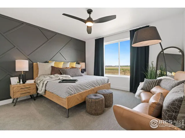 a bedroom with furniture and a ceiling fan