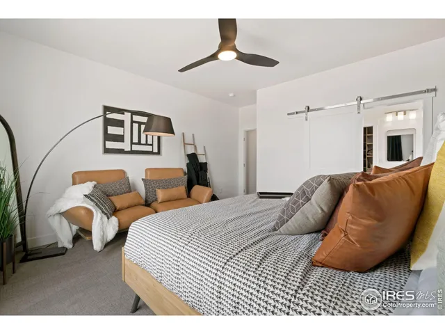 a bedroom with bed and a chandelier