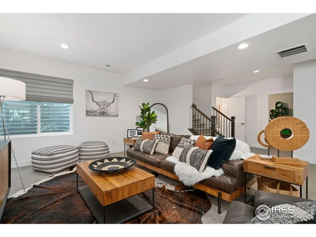 a living room with furniture a window and a painting on the wall