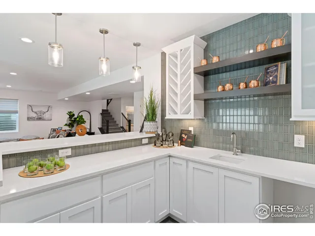 a kitchen with a table chairs refrigerator and cabinets