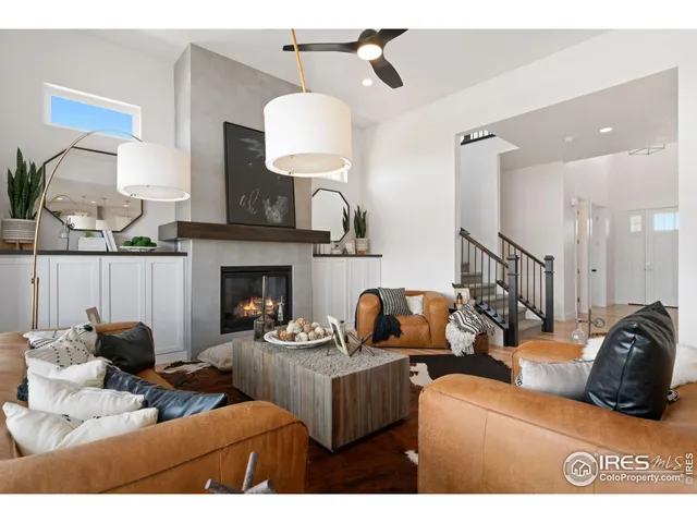 a living room with furniture a fireplace and a potted plant