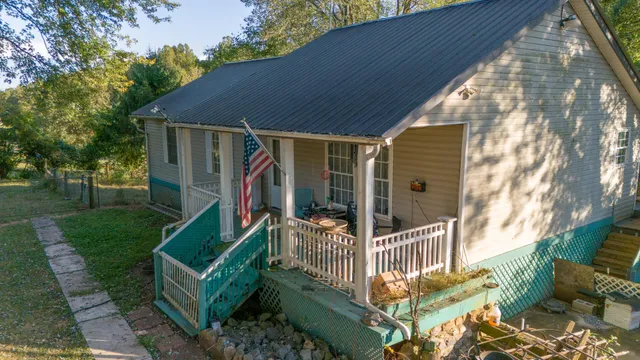 a view of a house with a small yard and wooden fence