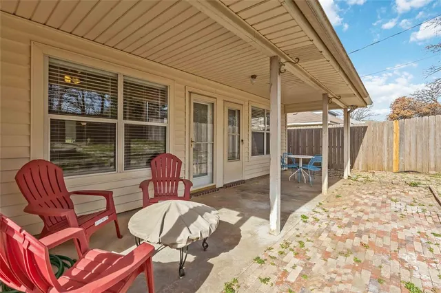 a view of a patio with a table and chairs