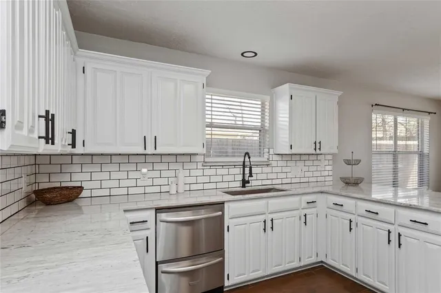 a kitchen with a sink and cabinets