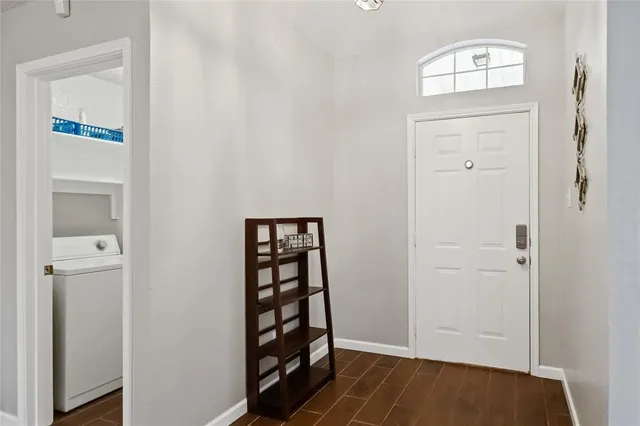 an empty room with wooden floor cabinet and closet