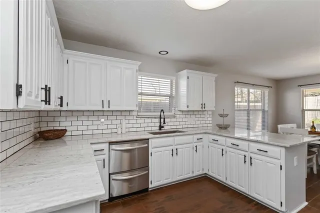 a kitchen with a sink stove and cabinets