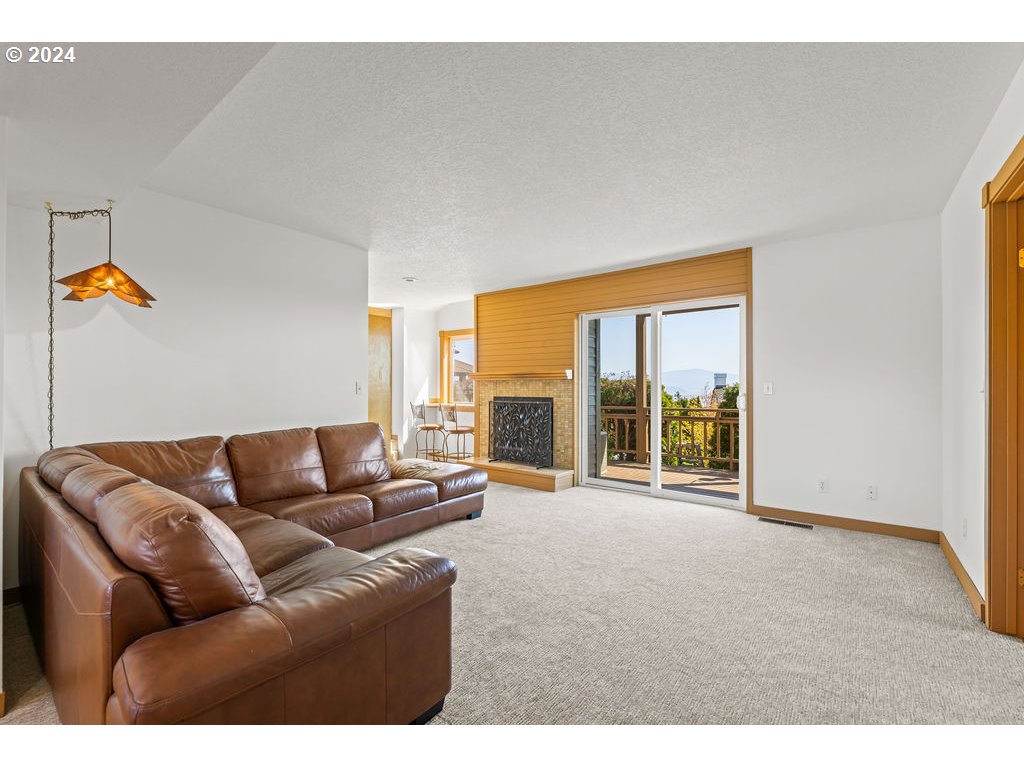 652 Northwest View Ridge Way Camas, WA 98607 - Photo 23 of 39 a living room with furniture and a floor to ceiling window