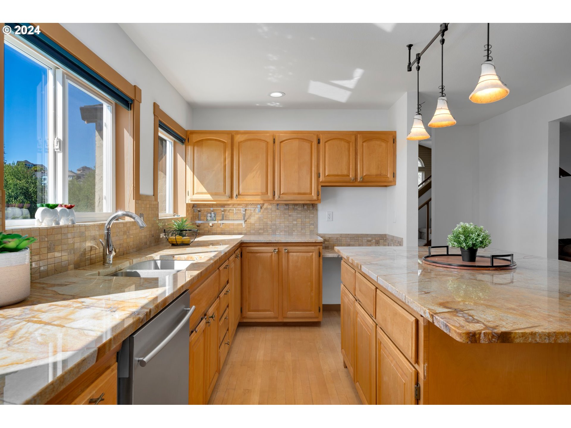 652 Northwest View Ridge Way Camas, WA 98607 - Photo 9 of 39 a kitchen with a sink a counter top space and living room filled with furniture