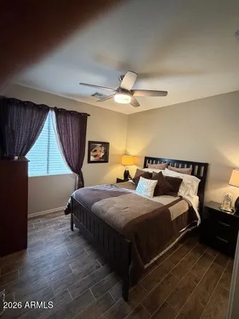 a bed sitting in a bedroom next to a window