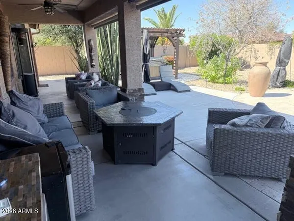a view of a backyard with a garden and entertaining space