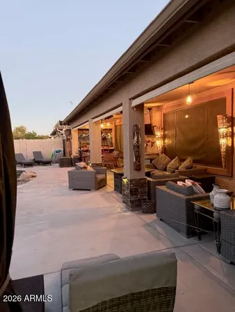 a living room with lots of furniture and chandelier