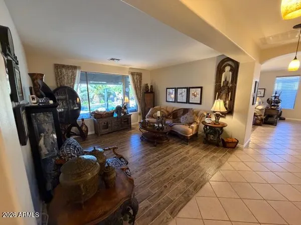 a dining room filled with furniture and a chandelier