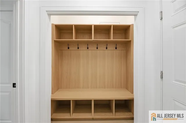 a living room with furniture a flat screen tv and a table