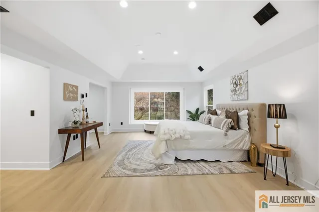 a bathroom with a sink a toilet a mirror and shower