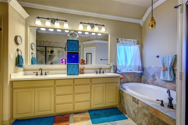 a bathroom with a tub sink and mirror