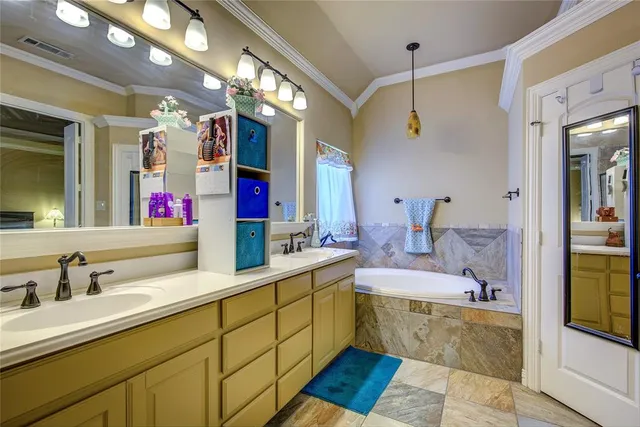 a bathroom with a tub sink and mirror