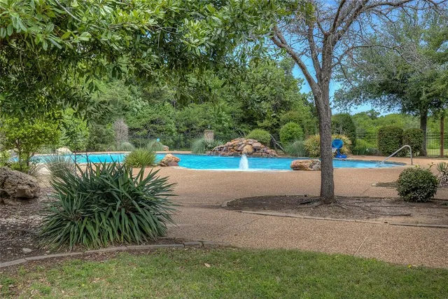 an aerial view of residential houses with outdoor space and lake view