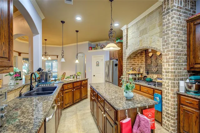 a kitchen with stainless steel appliances granite countertop a stove and cabinets